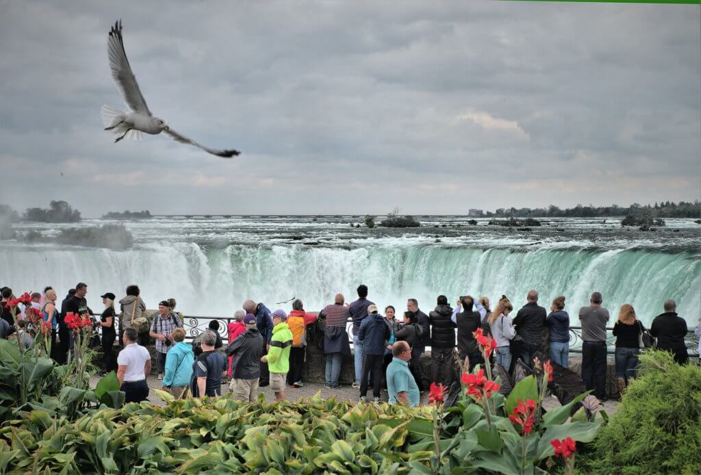 Tourists visit Niagara Falls in Ontario, Canada. Avoiding overcrowding is one way business travellers can help with sustainable travel.